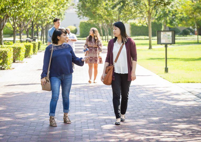 graduate students walk on campus